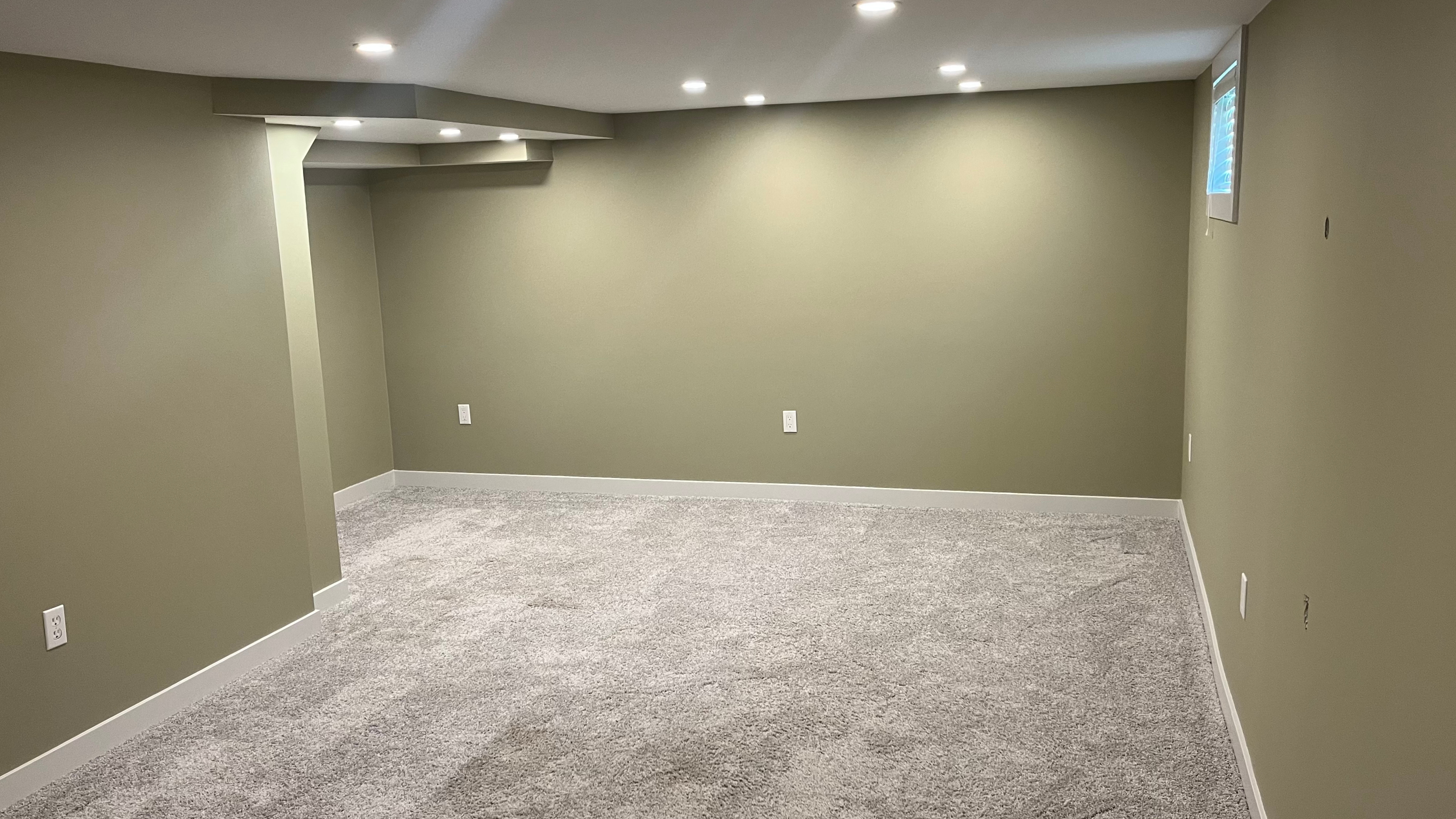 Basement living room with freshly painted walls and trim